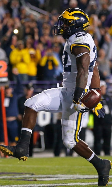 Michigan RB Higdon packed on muscle to give, take pounding
